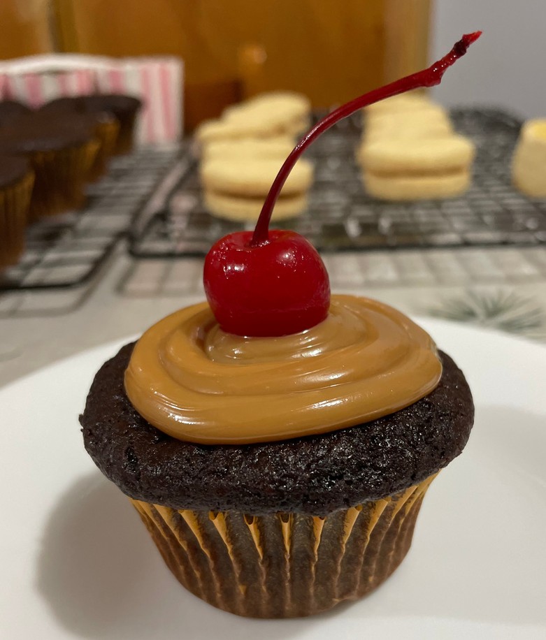 A cupcake with a cherry on top

Description automatically generated with medium confidence