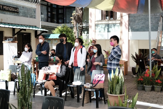 A group of people standing outside a restaurant
Description automatically generated with medium confidence